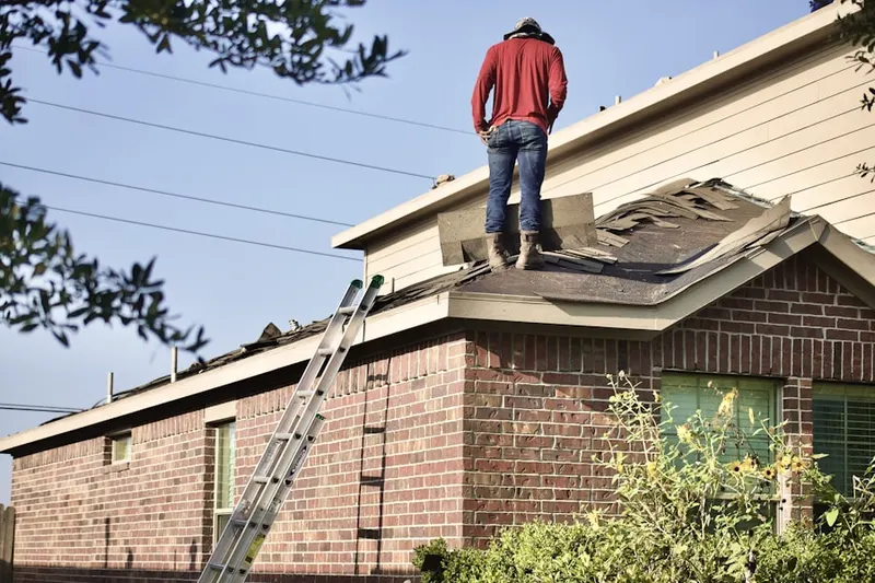 Professional roofer working on a residential roof in Long Point